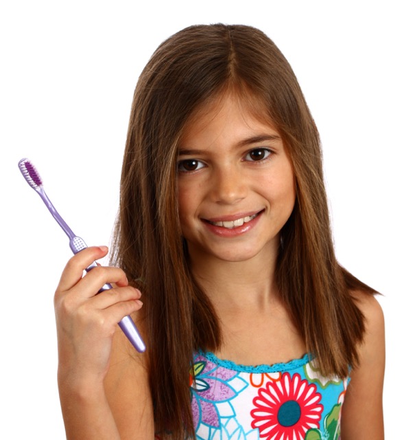 smiling girl holding toothbrush