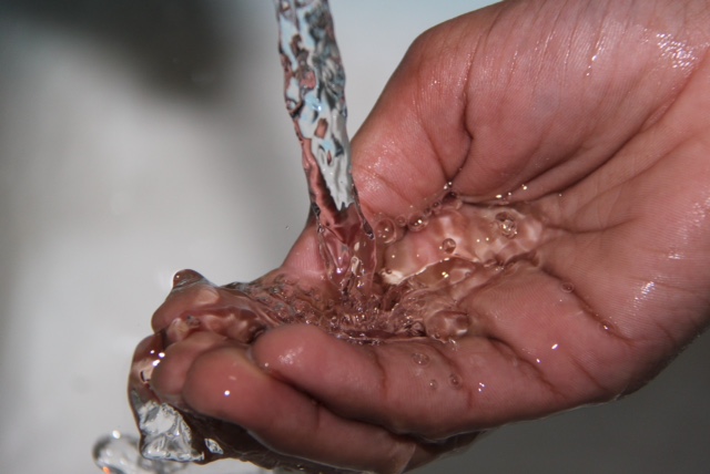 tap water pouring into hands - Mississauga Dentist - dry mouth